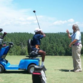 Military veteran golfing with PGA professional